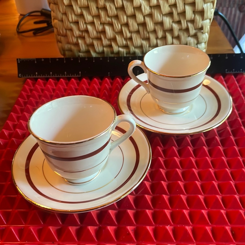 PAIR OF ANTIQUE MAROON AND GOLD DEMITASSE TEACUPS AND SAUCERS